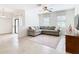 Comfortable living room with sectional sofa, ceiling fan, and access to patio at 8920 Dove Valley Way, Davenport, FL 33896