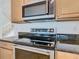 Stainless steel appliances and granite countertops in this well-equipped kitchen at 8920 Dove Valley Way, Davenport, FL 33896