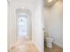 Clean hallway with archways leading to bedrooms and a small powder room at 8920 Dove Valley Way, Davenport, FL 33896