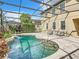 Inviting kidney-shaped pool with a screened enclosure at 8920 Dove Valley Way, Davenport, FL 33896