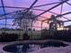 Relaxing pool and patio area with sunset view at 8920 Dove Valley Way, Davenport, FL 33896