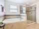 Elegant bathroom with a large soaking tub and a separate walk-in shower at 8920 Dove Valley Way, Davenport, FL 33896