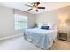 Bright bedroom with a king-size bed, window coverings and ceiling fan at 8920 Dove Valley Way, Davenport, FL 33896