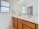 Bathroom with double vanity and neutral tones at 8920 Dove Valley Way, Davenport, FL 33896