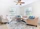 Cozy sitting area with a curved sofa and an accent chair at 8920 Dove Valley Way, Davenport, FL 33896