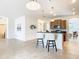 Spacious kitchen with island, stainless steel appliances, and light wood cabinets at 8920 Dove Valley Way, Davenport, FL 33896