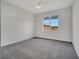 Spacious bedroom with gray carpet and a large window at 817 Terrace Ridge Cir # 817, Davenport, FL 33896