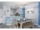 Charming dining area with a farmhouse table and beachy wall decor at 3052 Secret Lake Dr, Kissimmee, FL 34747