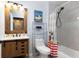 Bathroom with rustic vanity, shower, and Mickey Mouse decor at 3052 Secret Lake Dr, Kissimmee, FL 34747