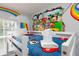 Mickey Mouse themed twin-size bed with colorful wall decor at 3052 Secret Lake Dr, Kissimmee, FL 34747