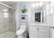 Clean bathroom with a shower, toilet, vanity, and marble countertop at 3052 Secret Lake Dr, Kissimmee, FL 34747