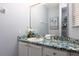 Clean bathroom boasts a stone-like countertop, a sink, and a large mirror at 3052 Secret Lake Dr, Kissimmee, FL 34747