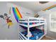 Mickey Mouse themed bedroom with a bunk bed and rainbow wall art at 3052 Secret Lake Dr, Kissimmee, FL 34747