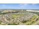 Aerial view of a residential community with houses, green spaces, and a lake at 2261 Standing Rock Cir, Oakland, FL 34787