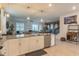 Open kitchen with island, stainless steel appliances, and breakfast bar at 9102 Sommerset Hills Dr, Davenport, FL 33896