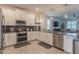 Open concept kitchen featuring stainless steel appliances at 9102 Sommerset Hills Dr, Davenport, FL 33896