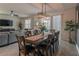 Bright dining room featuring a wood table, six chairs, and a modern chandelier at 9102 Sommerset Hills Dr, Davenport, FL 33896