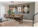 Open concept dining area with a statement wall and a wood dining table at 9102 Sommerset Hills Dr, Davenport, FL 33896