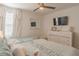 Light and bright bedroom with twin and full-size beds, a dresser, and TV at 9102 Sommerset Hills Dr, Davenport, FL 33896