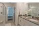Double vanity bathroom with a walk-in shower, and a view of a bedroom at 9102 Sommerset Hills Dr, Davenport, FL 33896