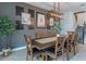 Elegant dining room with a large wooden table and gray accent wall with framed art at 9102 Sommerset Hills Dr, Davenport, FL 33896