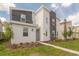 Two-story modern home with gray and white exterior and landscaping at 9102 Sommerset Hills Dr, Davenport, FL 33896