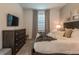 Bedroom with dresser, TV, and comfy bed at 9102 Sommerset Hills Dr, Davenport, FL 33896