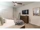 Bedroom with dresser, TV and comfy bed at 9102 Sommerset Hills Dr, Davenport, FL 33896