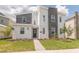 Two-story modern home with gray and white exterior and landscaping at 9102 Sommerset Hills Dr, Davenport, FL 33896
