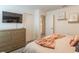 Bedroom with dresser and large TV at 9102 Sommerset Hills Dr, Davenport, FL 33896