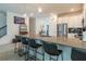 Modern kitchen with stainless steel appliances and a large island with seating at 9102 Sommerset Hills Dr, Davenport, FL 33896