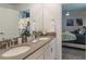 Double vanity bathroom with a walk-in shower, and a view of a bedroom at 9102 Sommerset Hills Dr, Davenport, FL 33896