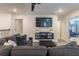Game room with sectional sofa, mounted TV, and hallway access at 9102 Sommerset Hills Dr, Davenport, FL 33896