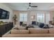 Relaxing living room featuring a sectional sofa, large TV, and plenty of natural light at 9102 Sommerset Hills Dr, Davenport, FL 33896