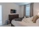 Bedroom with dresser, TV, and comfy bed at 9102 Sommerset Hills Dr, Davenport, FL 33896