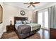 King bedroom with hardwood floors, ceiling fan and access to balcony at 735 Golden Bear Dr, Reunion, FL 34747