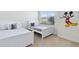Two twin beds in a bright bedroom with Mickey Mouse wall decal at 17204 Blessing Dr, Clermont, FL 34714