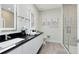 Modern bathroom with a walk-in shower, floating vanity, and sleek fixtures at 17204 Blessing Dr, Clermont, FL 34714