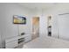 Spacious bedroom with TV, and view of the upstairs hallway at 17204 Blessing Dr, Clermont, FL 34714