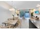 Open concept dining area with modern table and access to the patio at 17204 Blessing Dr, Clermont, FL 34714