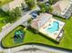 Aerial view of community pool, playground, and surrounding homes at 17204 Blessing Dr, Clermont, FL 34714