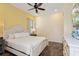 King-size bed, dresser, TV, and ceiling fan in this bright bedroom at 8063 Knee Deep Rd, Kissimmee, FL 34747