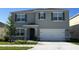 Two-story house with gray siding and white garage door at 4105 Giorgio Dr, Winter Haven, FL 33884