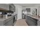 Modern kitchen with gray cabinets, stainless steel appliances, and granite countertops at 4105 Giorgio Dr, Winter Haven, FL 33884