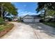 Single-Gathering home with a three-car garage and circular driveway at 2717 Bayview Dr, Eustis, FL 32726