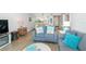 Bright living room with comfy sofas, coastal decor, and wood-look floors at 2100 Ocean Shore Blvd # 203, Ormond Beach, FL 32176