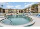 Community pool with plenty of lounge chairs at 2100 Ocean Shore Blvd # 203, Ormond Beach, FL 32176