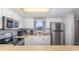 Clean kitchen featuring stainless steel appliances and white cabinets at 2100 Ocean Shore Blvd # 203, Ormond Beach, FL 32176