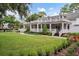 White house with large front porch and landscaping at 235 Oakdale St, Windermere, FL 34786