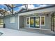 Home's exterior features double doors that open to the pool at 235 Oakdale St, Windermere, FL 34786